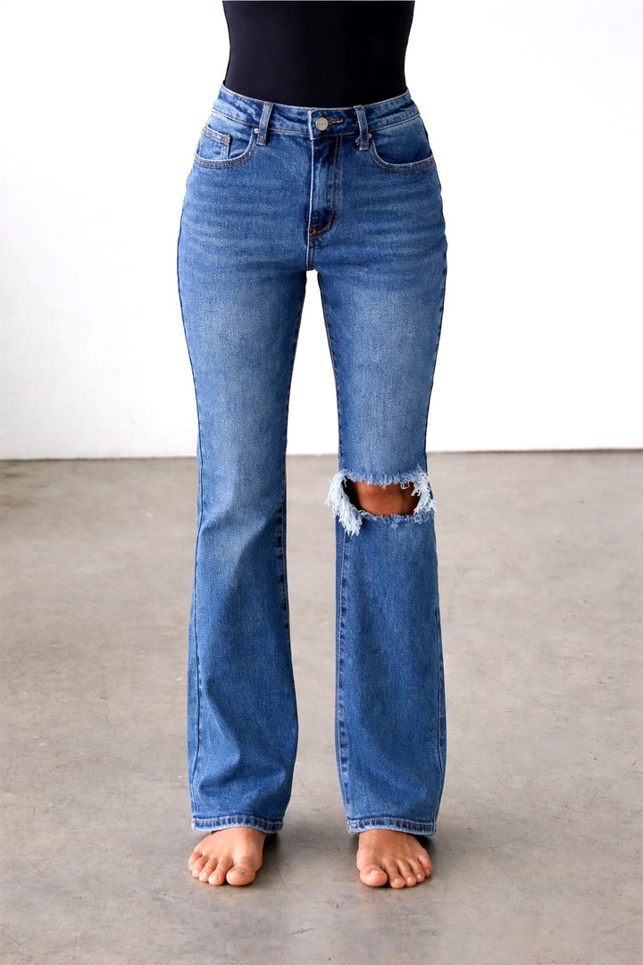 Person wearing blue jeans with a white background